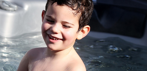 A happy boy in a hot tub