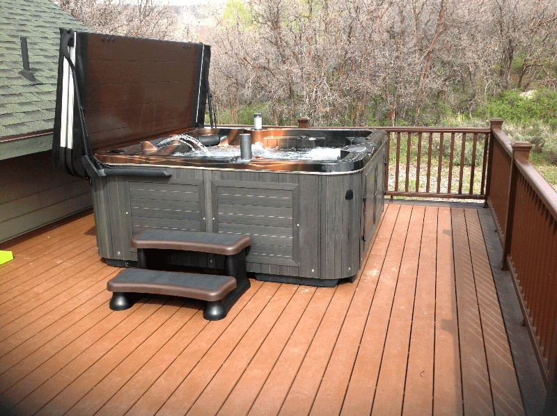 Arctic Spas Hot tub with an open cover on deck